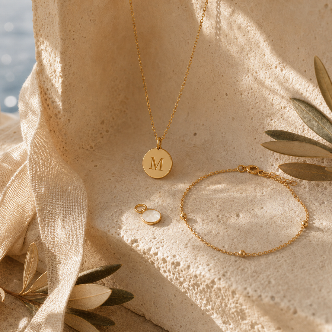 Personalised initial necklace and bracelet on warm stone
